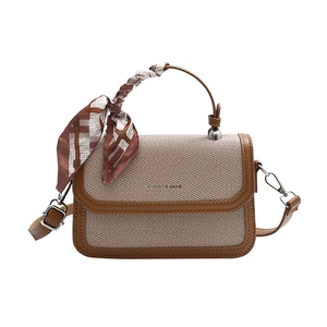 Chic beige woven handbag with brown leather trim and a checkered silk scarf handle detail