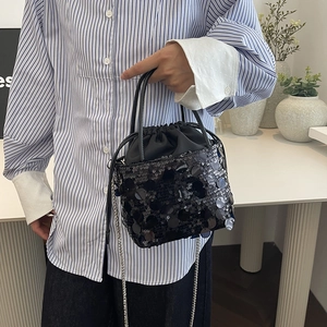 Chic black sequin bucket bag with drawstring closure and silver chain strap
