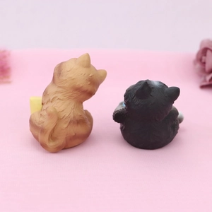 Rear view of cute resin orange and black cat figurines with detailed fur textures
