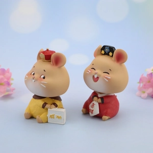 Close-up of two Chinese style resin hamster car ornaments with Success and Lucky symbols