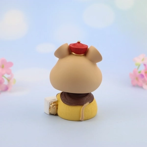 Detail view of Hani Mouse car ornament in yellow outfit with traditional red cap
