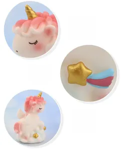 Close-up of the unicorn cake topper showing golden horn and pastel wing details