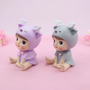 Close-up of cute resin doll ornaments in elk hoodies for cake topper and car decor