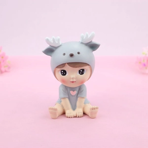 Cute doll cake topper in gray deer costume with pink heart on a pink background