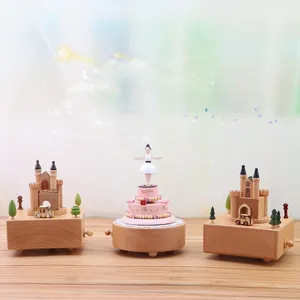 Detailed view of handcrafted wooden music boxes featuring castle and birthday cake designs