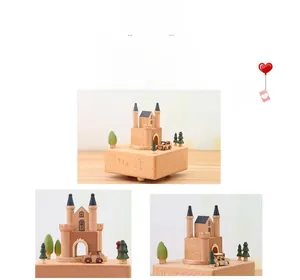 Detail of wooden castle music box featuring twin spires and a miniature car on base