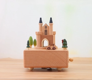 Detailed macro shot of the wooden castle music box showing the winding mechanism