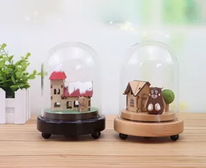 Detail of wooden music box with glass dome, miniature scenes and dual-color base