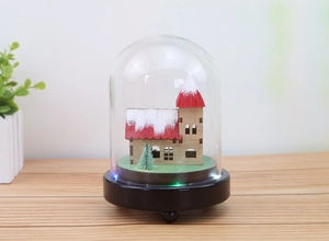 Macro detail of Christmas micro landscape with LED lights inside a clear glass dome