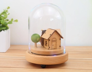 Detail of wooden miniature scene with blue LED lights inside a clear glass dome