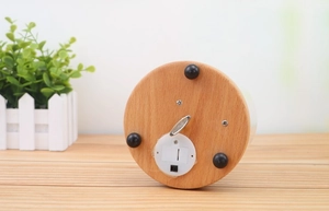 Detailed bottom view of wooden music box base with wind-up key and battery compartment
