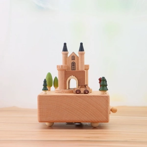 Castle-themed wooden music box with miniature car and trees on a natural beech base