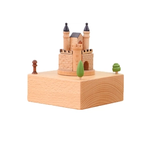Handcrafted wooden castle music box with miniature trees on a natural wood base