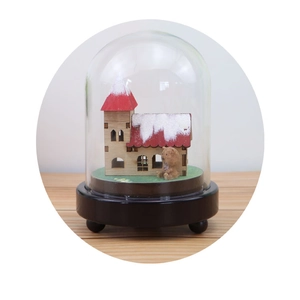 Castle in the Sky music box with miniature wooden house and bear in a glass dome