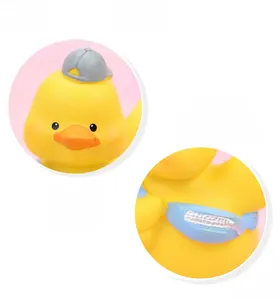 Close-up of cute yellow duck car ornament with a grey cap and blue rhinestone bag detail