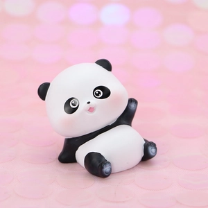 Close-up of cute cartoon panda figurine with pink cheeks and expressive eyes decoration