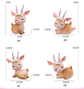 Detailed view of four deer cake toppers with pastel floral crowns and translucent antlers