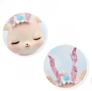 Macro detail of a pink resin deer topper with flower crown and translucent antlers