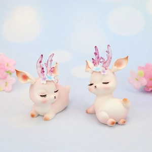 Pink Christmas deer cake toppers with purple translucent antlers and floral details