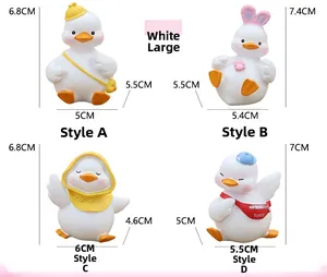 Set of four cute white resin ducks in different outfits for car interior and cake decor