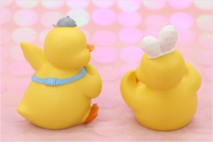 Rear view of cute yellow duck car ornaments with grey cap and white rabbit ears