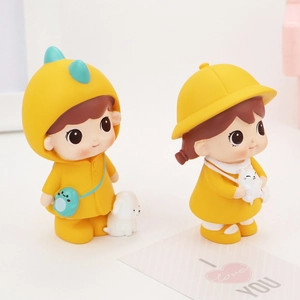 Detail of cute boy in dinosaur hoodie and girl with cat resin desktop ornaments