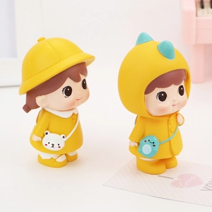 Close-up of cute yellow car ornaments featuring a bear bag and dinosaur hoodie dolls