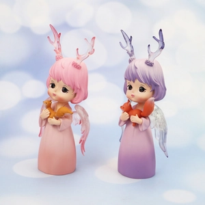 Close-up of pastel deer girl figurines with translucent wings for car and room decor