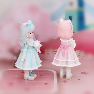 Detailed view of cute anime girl figurines in pink and blue Lolita dresses for car decor