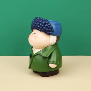 Detail of creative Nordic half-moon artist storage bin with cartoon figure design