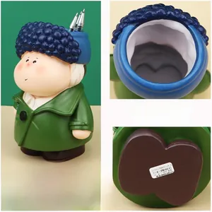 Detail of artistic resin pen holder featuring a vintage figure with a blue beaded hat