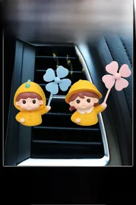 Close-up of cute cartoon characters cartoon boy and girl car air vent perfume clips