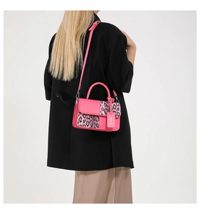 Fashionable pink leather and leopard print crossbody bag worn with a black blazer