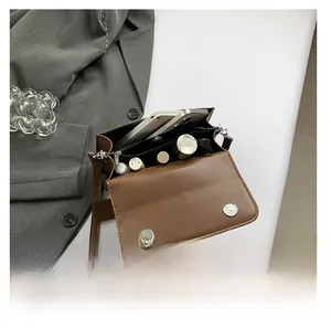 Interior view showing capacity for smartphone and cosmetics in a vintage brown handbag