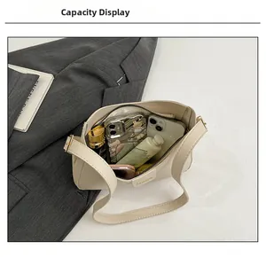 Detail view of the cream minimalist tote bag showing interior capacity and daily essentials