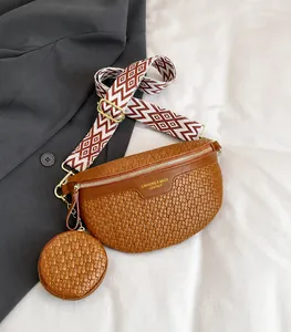 Detailed view of brown woven fanny pack with round coin purse and geometric strap