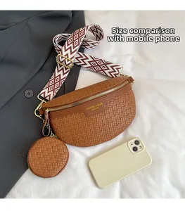 Detail of woven fanny pack with a round coin purse and wide strap compared to a phone