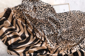 Detail shot of leopard and zebra print silk scarf showing soft texture on faux fur