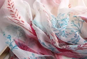 Detail of elegant floral scarf showing translucent chiffon texture and colorful prints