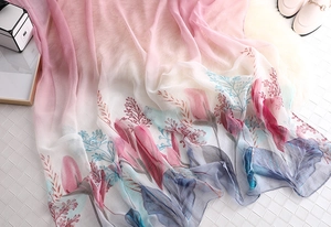Close-up of pink gradient scarf with tulip print and light semi-transparent texture
