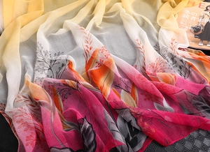 Detailed texture of gradient chiffon shawl with elegant floral leaf pattern and soft drape