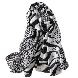 Elegant black and white animal print silk scarf with leopard and zebra patterns on satin fabric