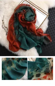 Détail de la texture jacquard florale sur foulard en soie aux couleurs contrastées bleu et orange