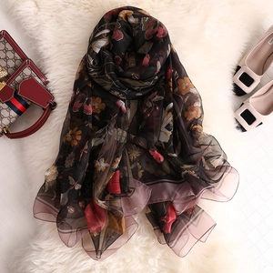 Floral print lightweight silk scarf with butterfly and lily patterns on black background