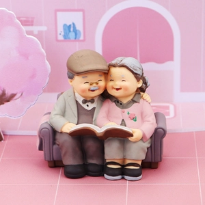 Resin elderly couple figurine on sofa reading book for cake topper and anniversary gift