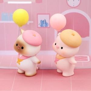 Close-up of cute cat and pig animal cake toppers with balloons and sailor outfits