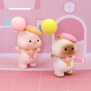 Cute pig and cat cake toppers in sailor outfits with matte balloons for birthday decor