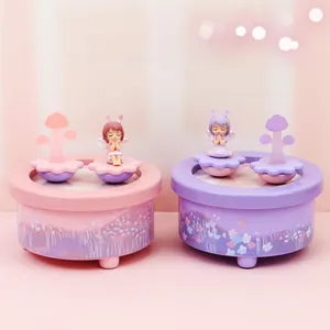 Detailed close-up of pink and purple musical boxes with cute angel bunny figurines