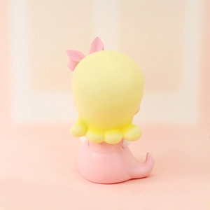 Rear view of a cute cartoon girl night light figurine with pink bow and yellow hair