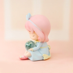 Detailed view of a cute resin girl figurine holding a floral crystal ball lamp decor